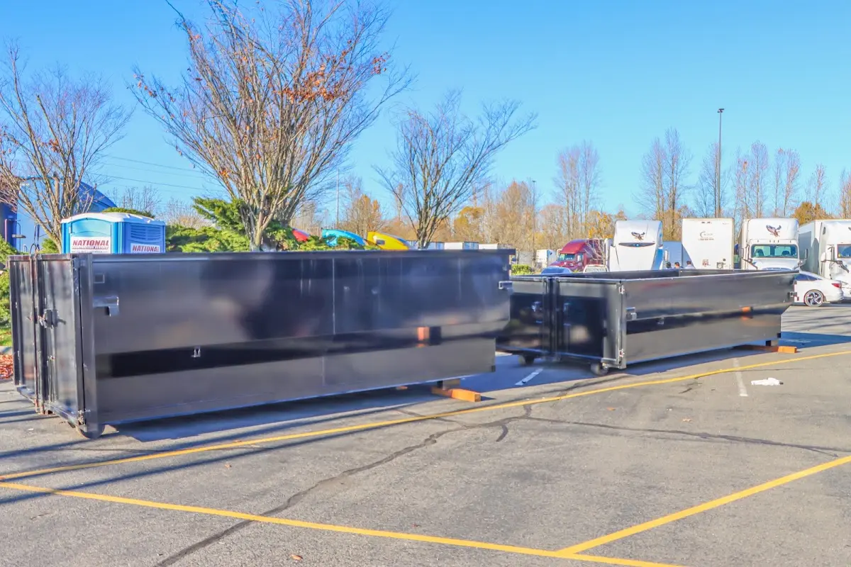 Professional dumpster rental service with roll-off container on residential driveway in Pike Road